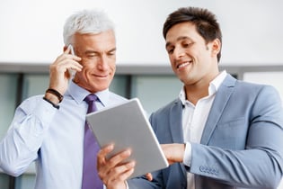 Two businessman in office with devices