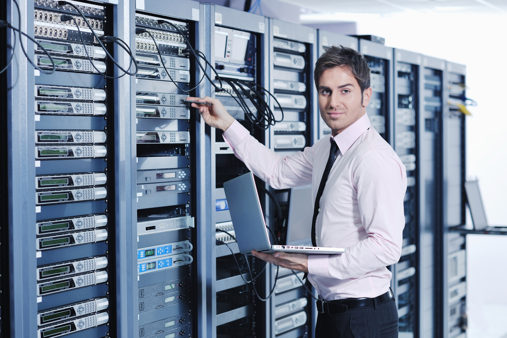 young handsome business man engeneer in datacenter server room-2 young handsome business man engeneer in datacenter server room-2